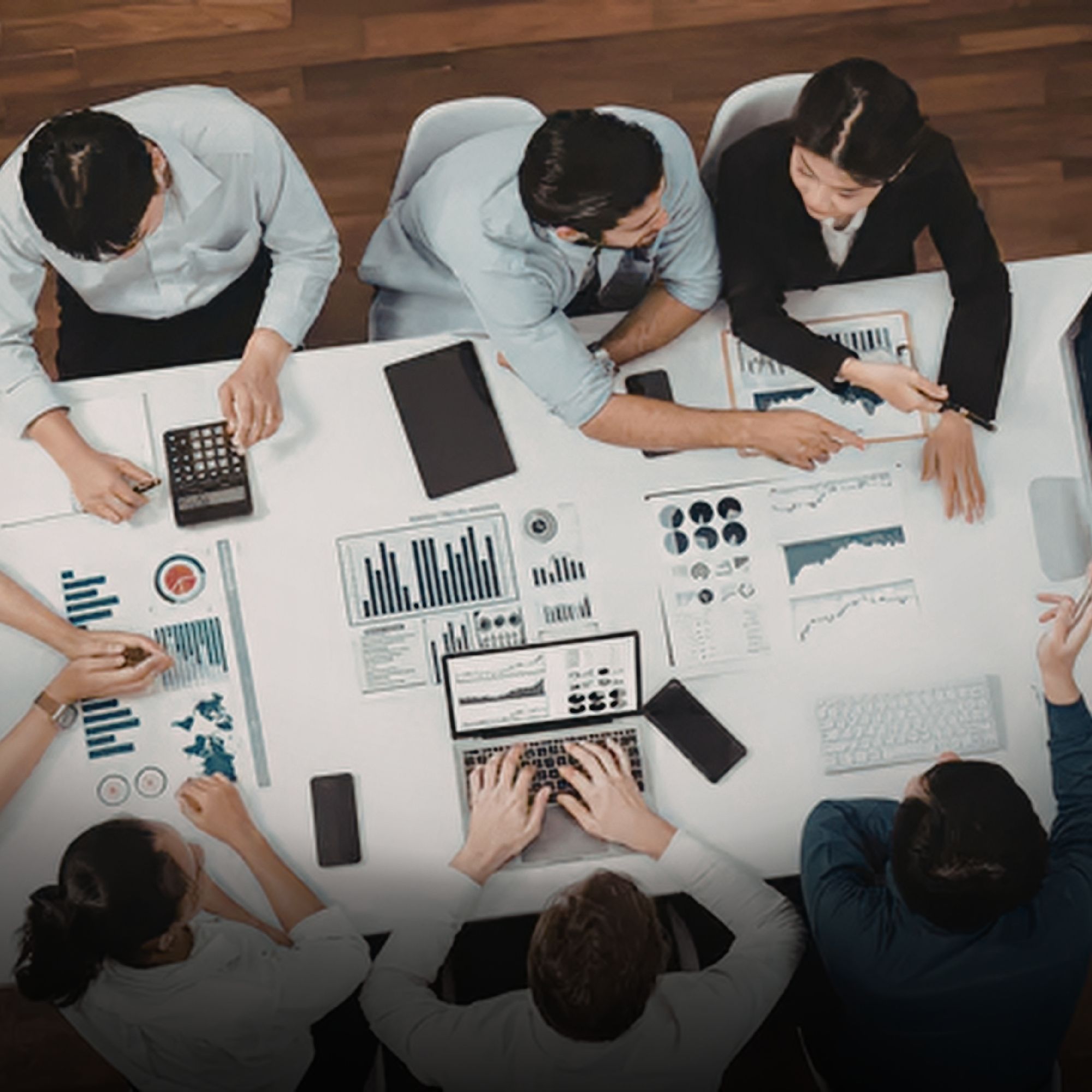 People around a desk looking at data